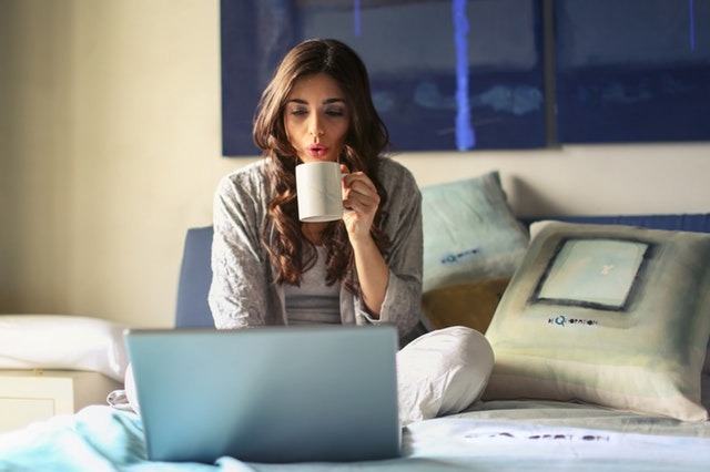 Woman at computer holding coffee, wondering if EBA is right for her